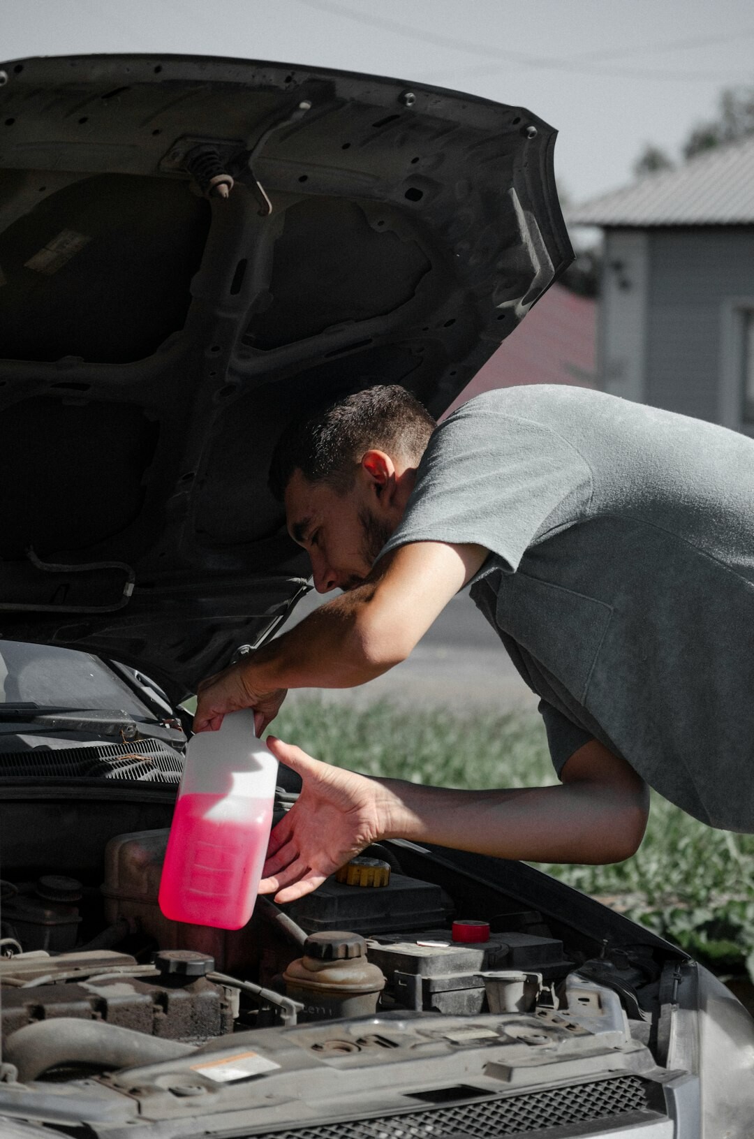 person inspecting car engine